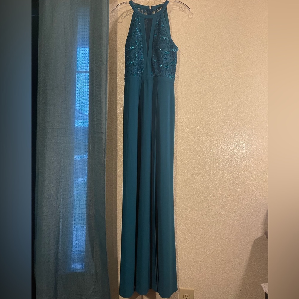 A long dark greenish color dress.